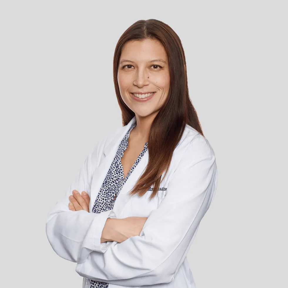 Dr. Jennifer Repac, a Wuffes veterinary advisor, in a white lab coat with her arms folded