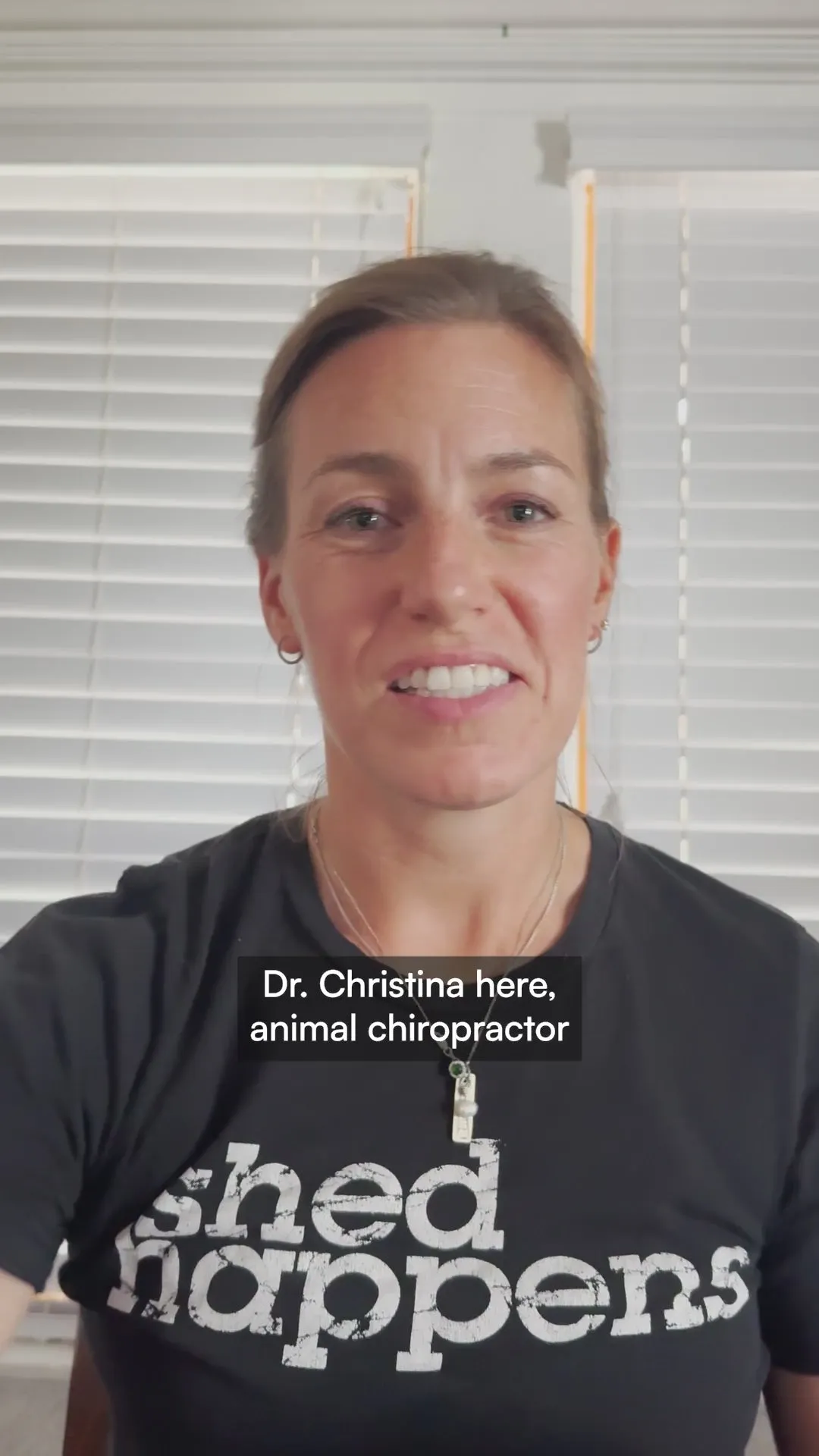 Dr. Christina, an animal chiropractor in a black t-shirt, introducing herself to camera