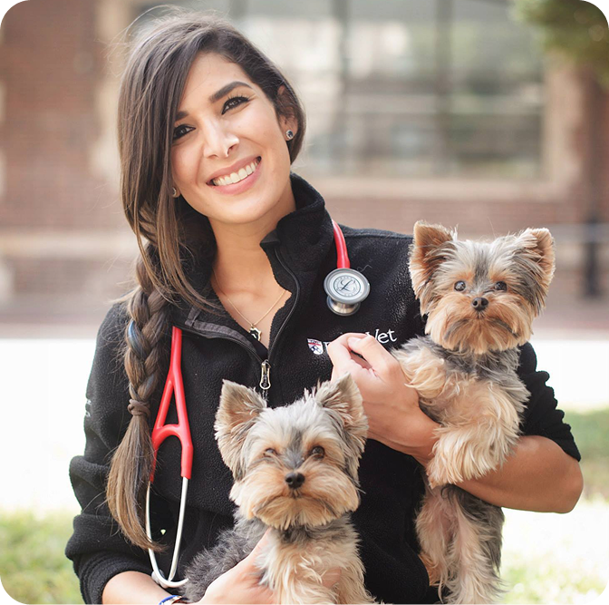 Dr. Tiffany Ruiz-Da Silva holding two small dogs